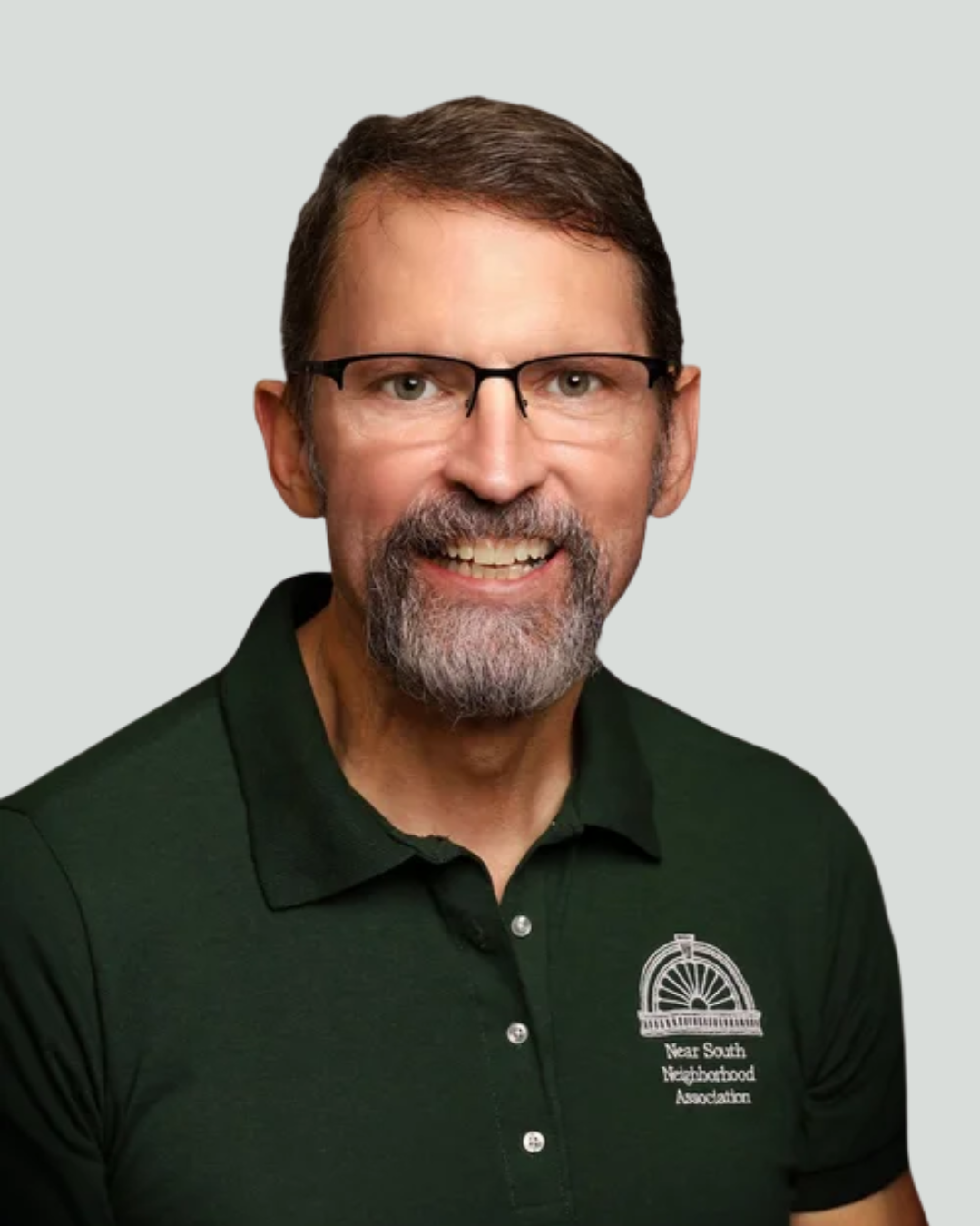 Headshot of smiling male tutor with medium-length black hair wearing a lanyard.