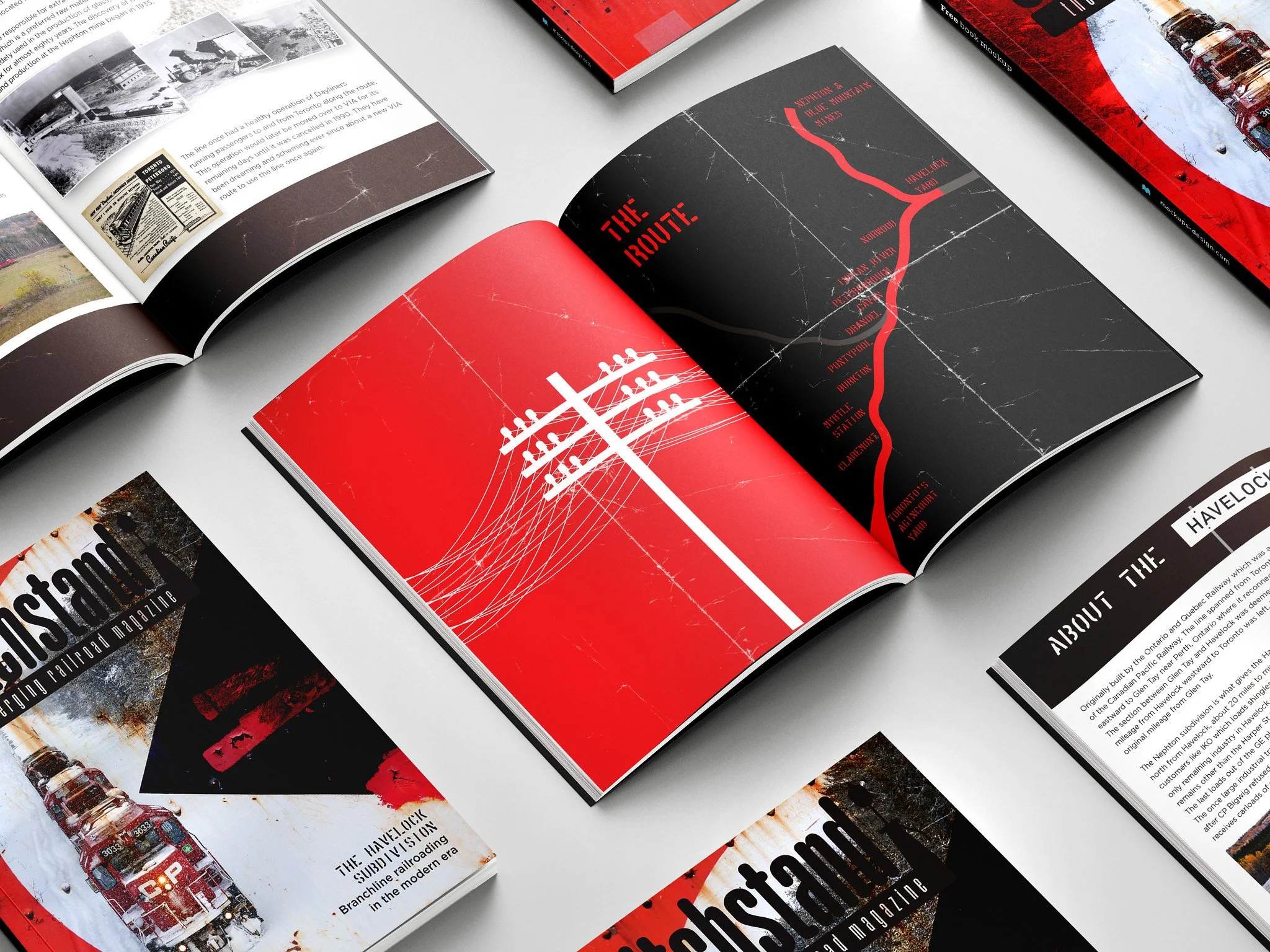 Open magazines displaying images and text about the Havelock Subdivision and its history, featuring a prominent red and black page with a utility pole illustration, and covers with images of trains and railroads.