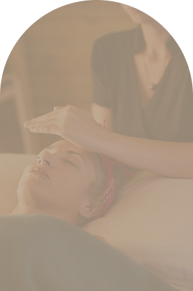 Person receiving a facial massage or skincare treatment from a professional in a spa or clinic setting.