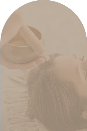 A person receiving a facial treatment with a jade roller on their forehead.