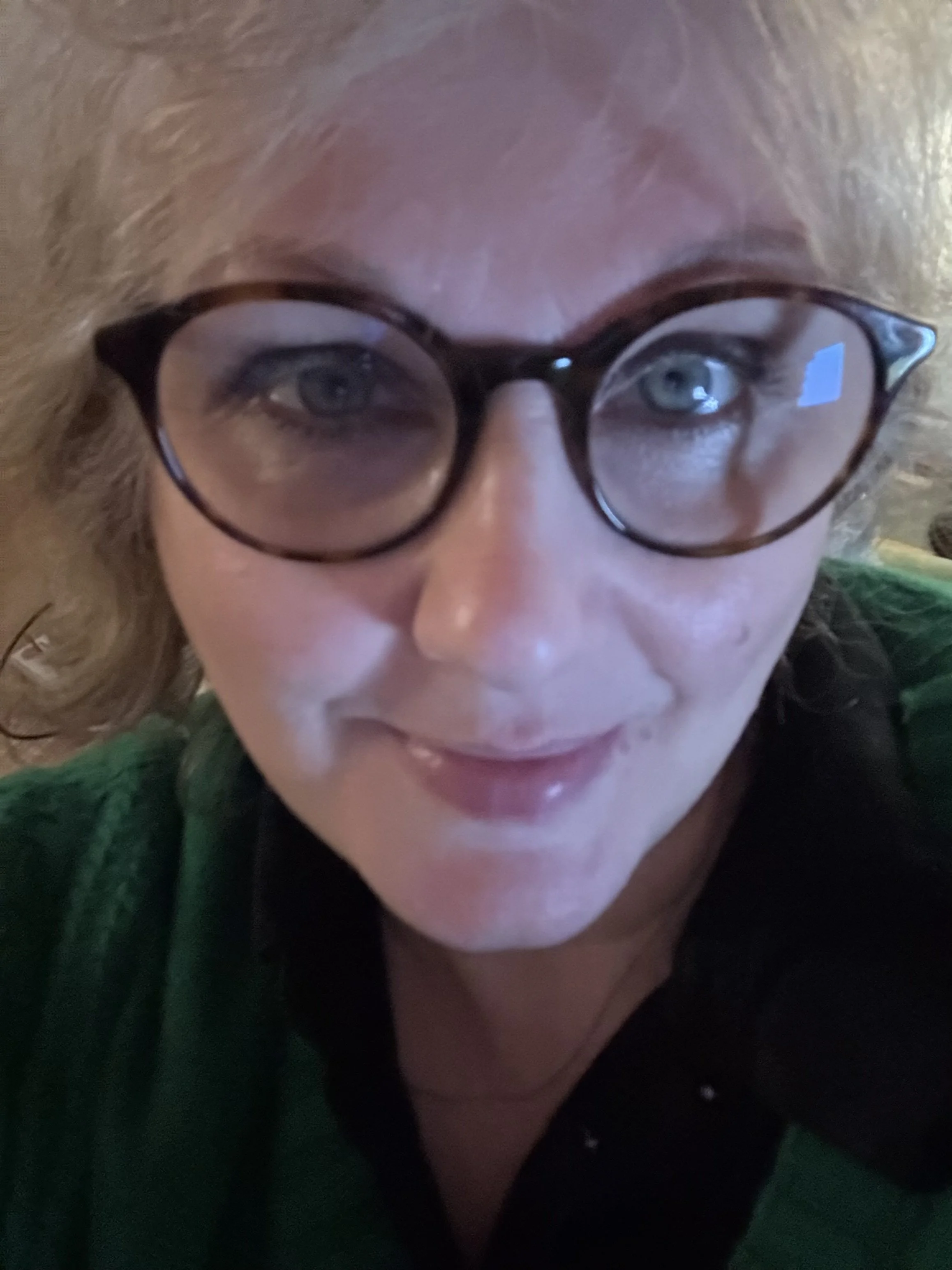 A photo of voice actor Emma Clarke, in soft lighting.