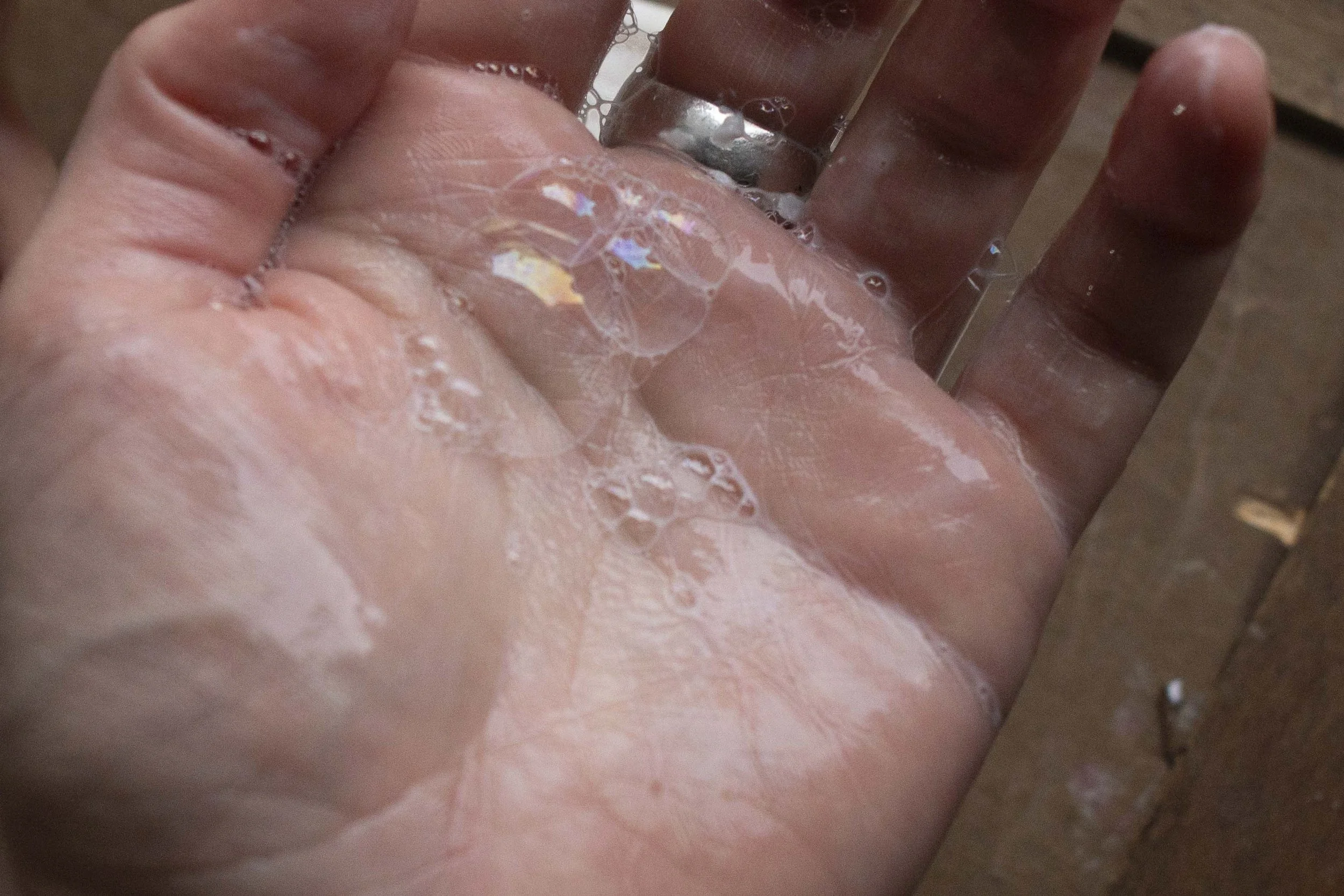 Close-up of a hand with soap and bubbles.