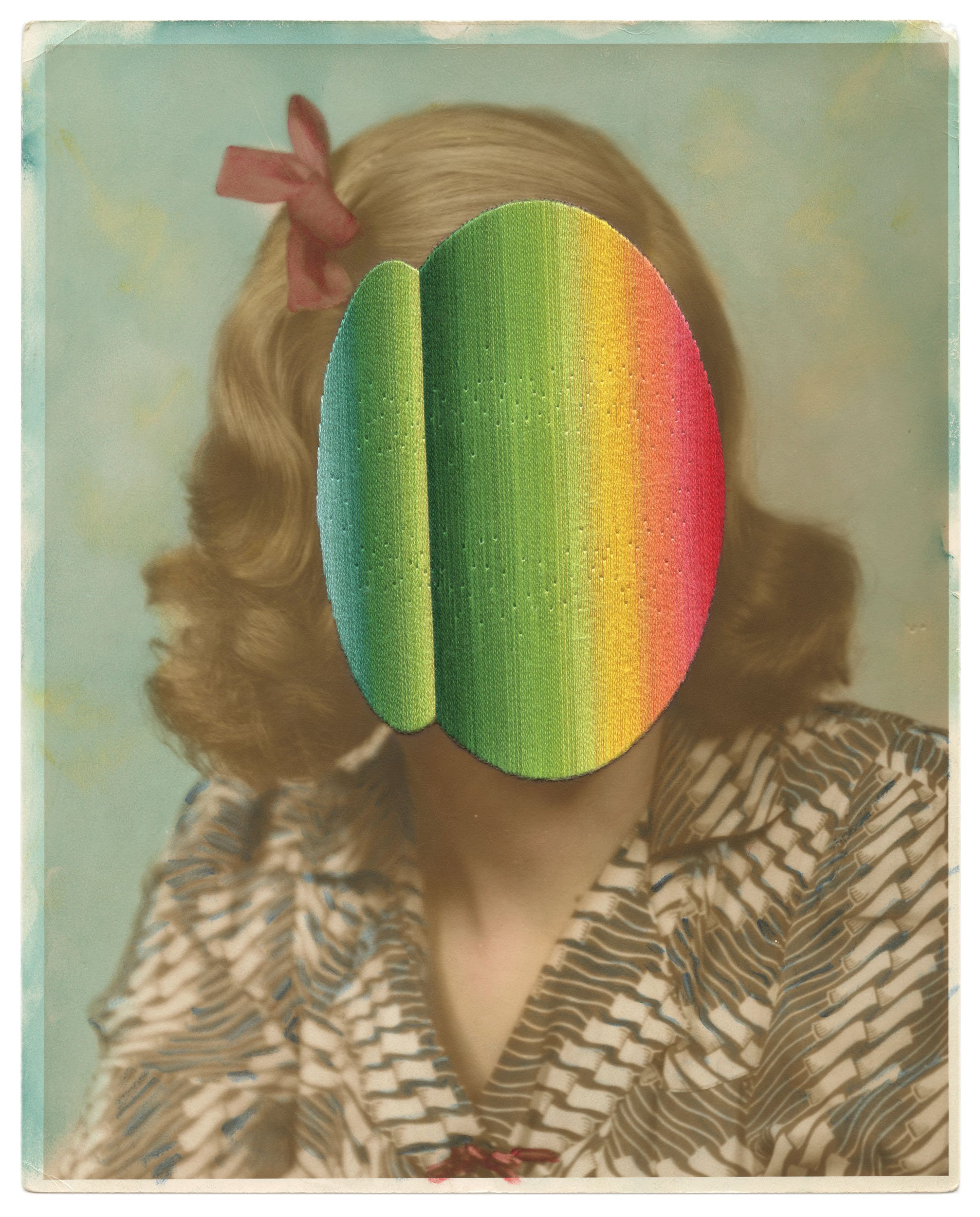 A person with long, curly blonde hair wearing a striped shirt and a red flower accessory in their hair, with their face obscured by a rainbow-colored oval shape.