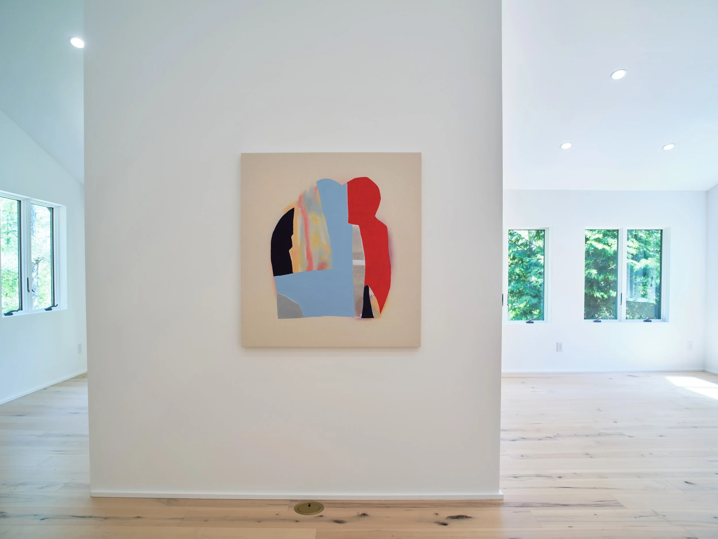 Modern art gallery with white walls, large windows, and a colorful abstract painting on the wall.