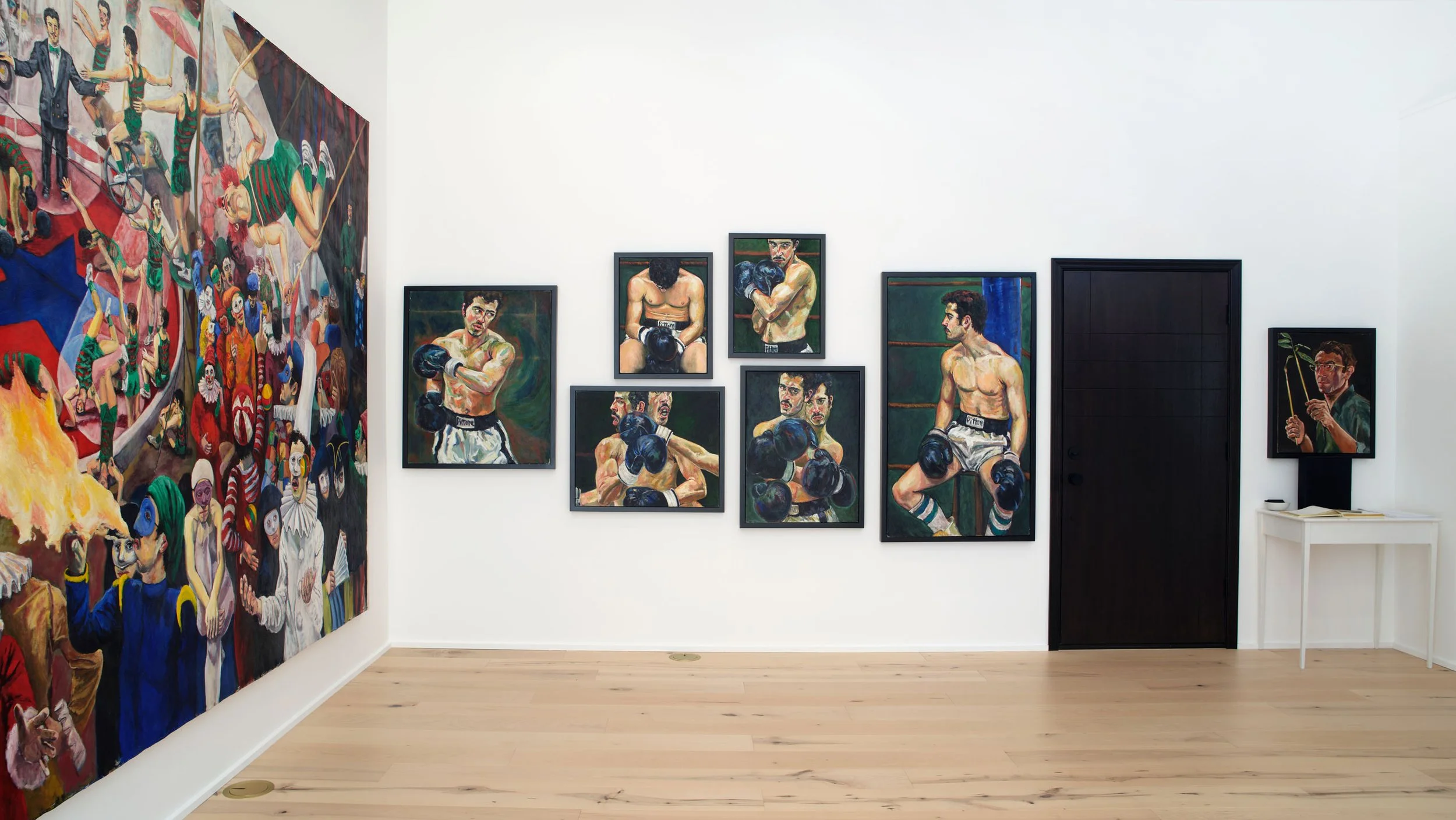 Gallery wall featuring paintings of male boxers and a colorful circus scene with clowns and performers.