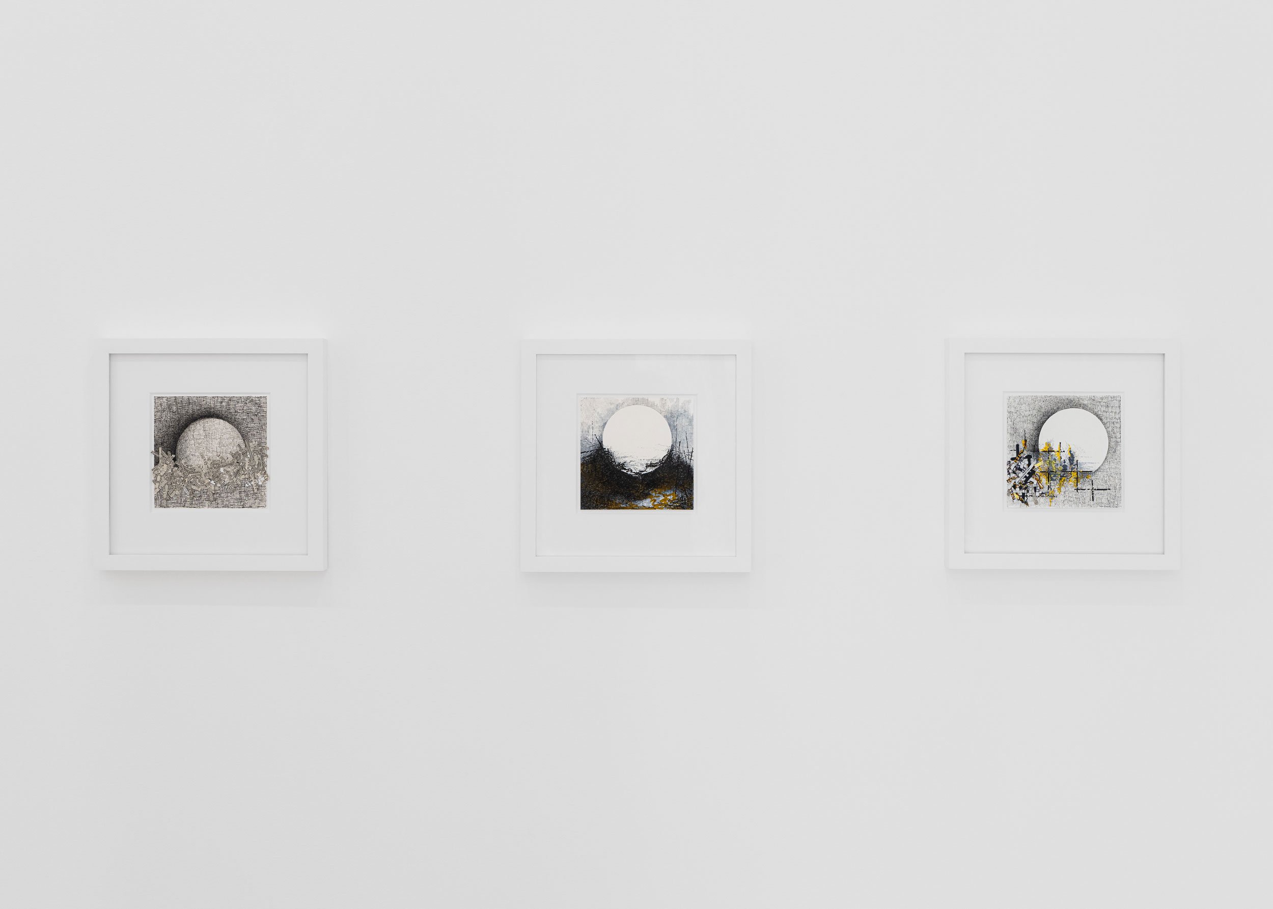 Three framed abstract artworks hung on a white gallery wall.