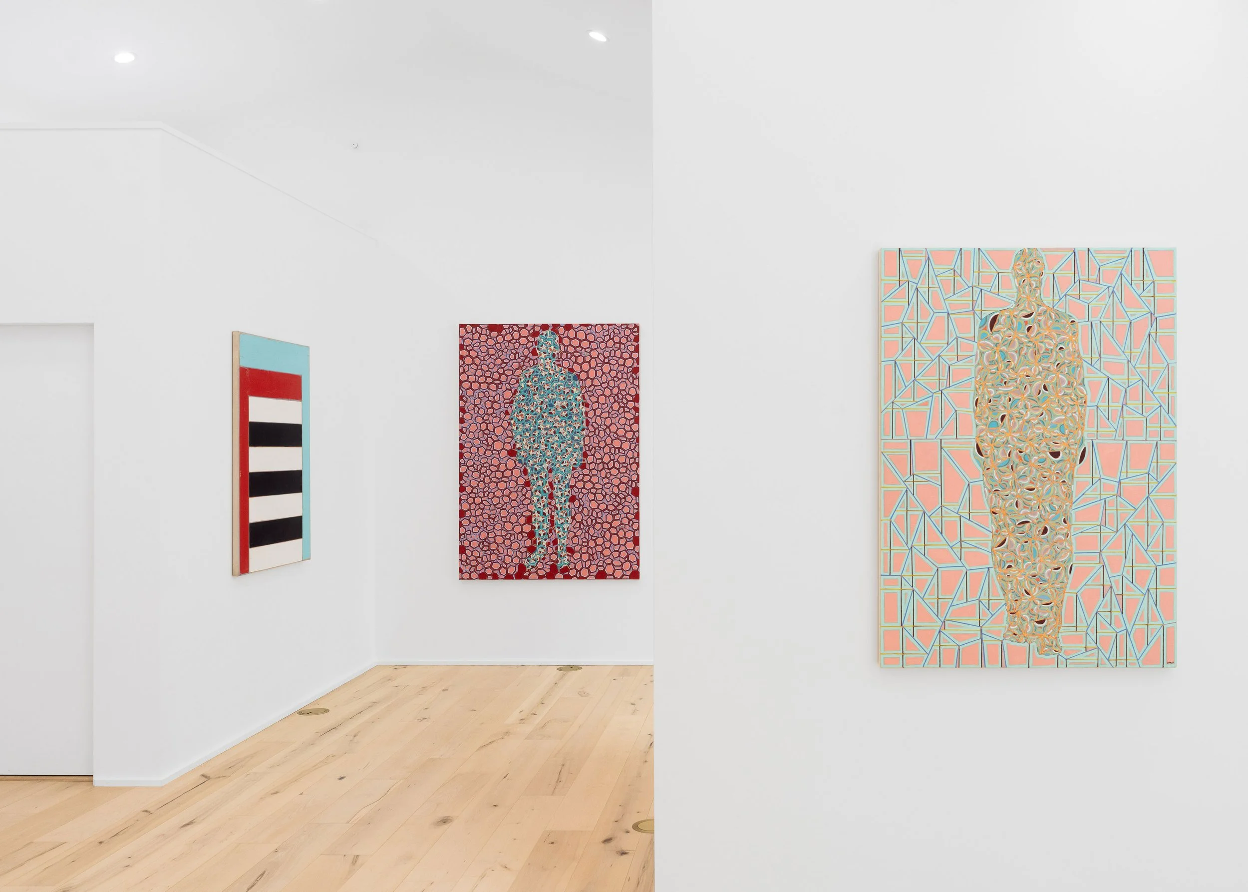 Art gallery with three colorful paintings on white walls, light wooden flooring, and ceiling lights.