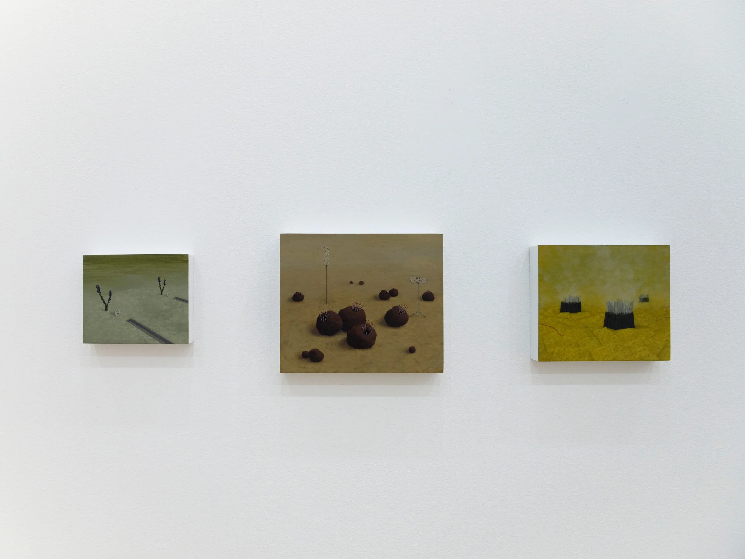 Three paintings of landscapes hung on a white gallery wall.