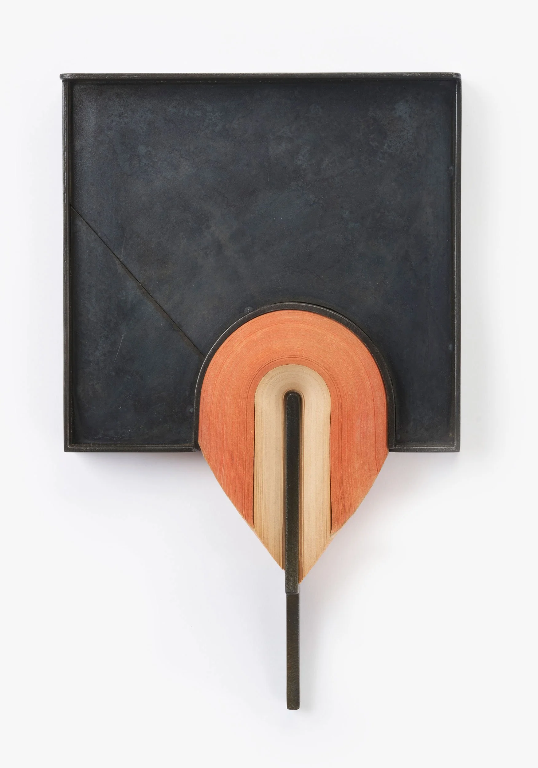 A black rectangular box with a round, orange and beige wooden object inside, resembling a combination of a box and a wooden sculpture.
