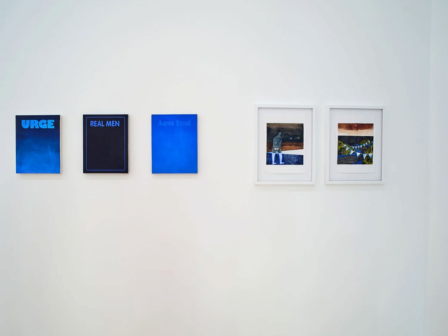 Art exhibit on a white wall featuring three blue posters with text and two framed images of a person and a landscape.