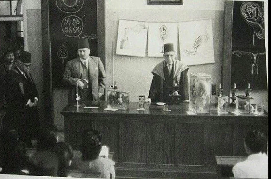 Dr. Naguib Pasha Mahfouz is delivering a lecture to the students, with King Farouk standing beside him (1942)