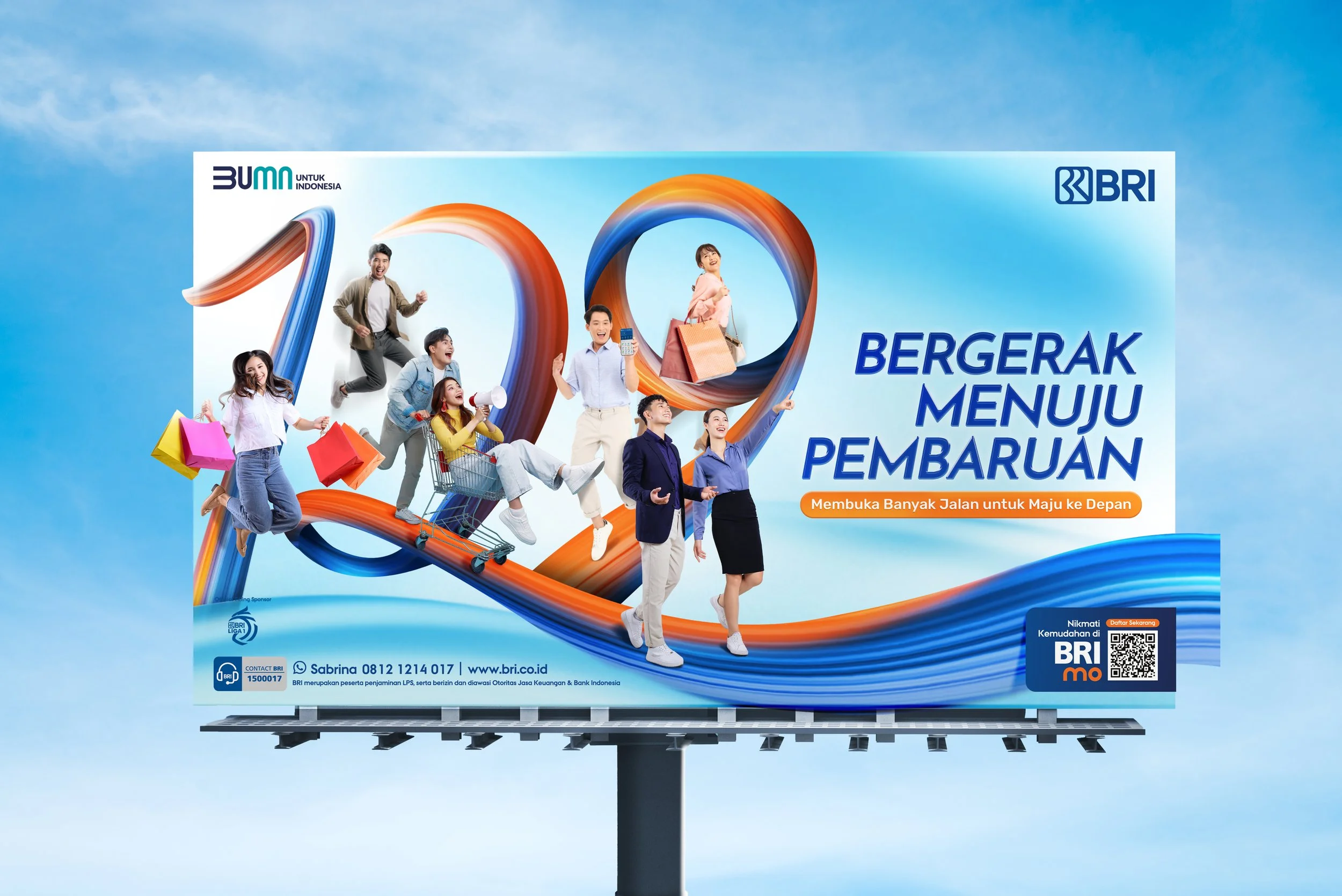 A billboard advertisement for BRI, an Indonesian bank, with an illustration of the number 100 and various people engaging in joyful activities such as shopping, jumping, and holding shopping bags, against a blue sky background. The text on the billboard is in Indonesian and promotes financial renewal and shopping convenience with BRI.