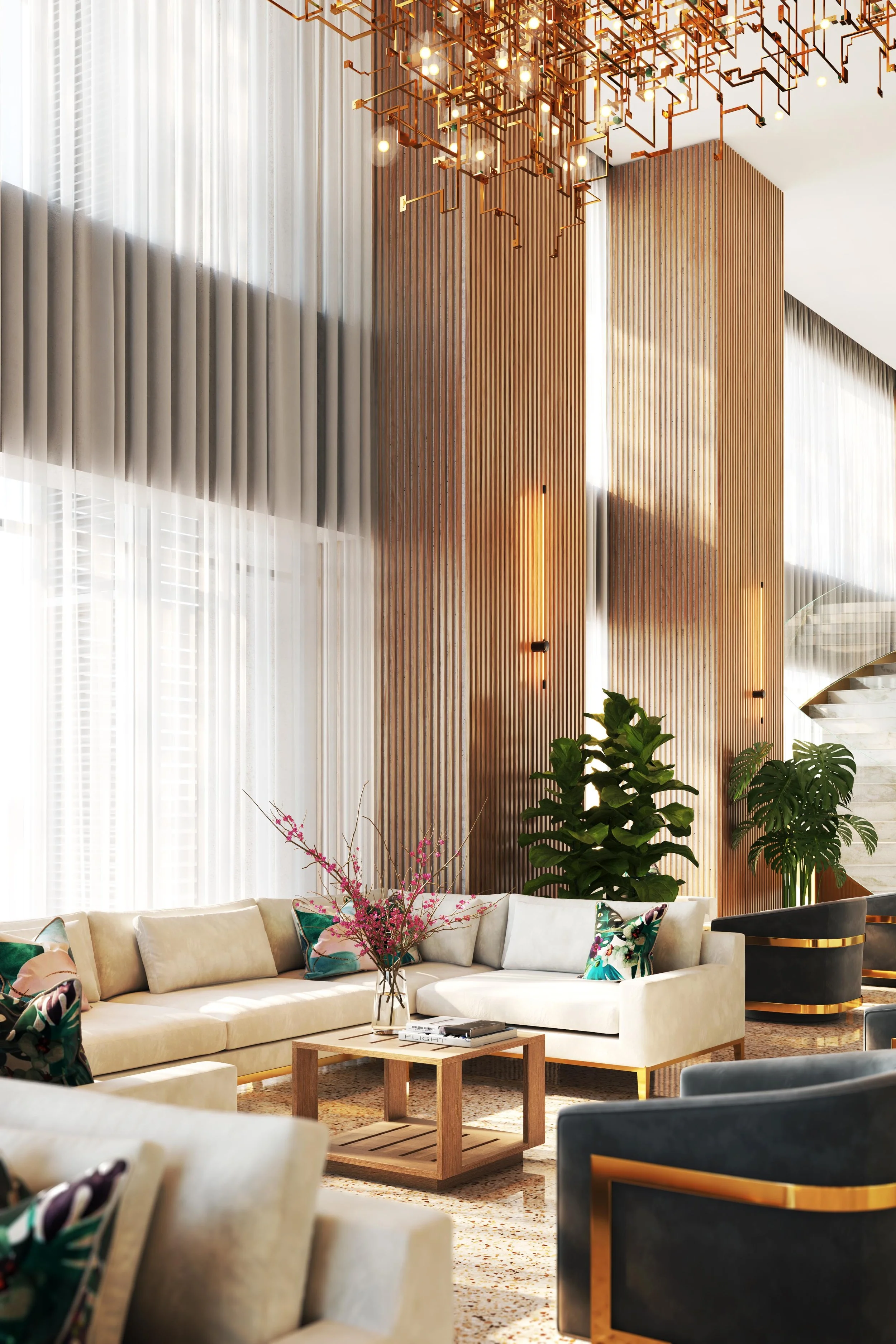 Elegant lobby (The Pinnacle) with large white sectional sofa, colorful pillows, a wooden coffee table with magazines, a pink floral arrangement, tall indoor plants, sheer curtains, modern lighting fixture, and a staircase in the background.