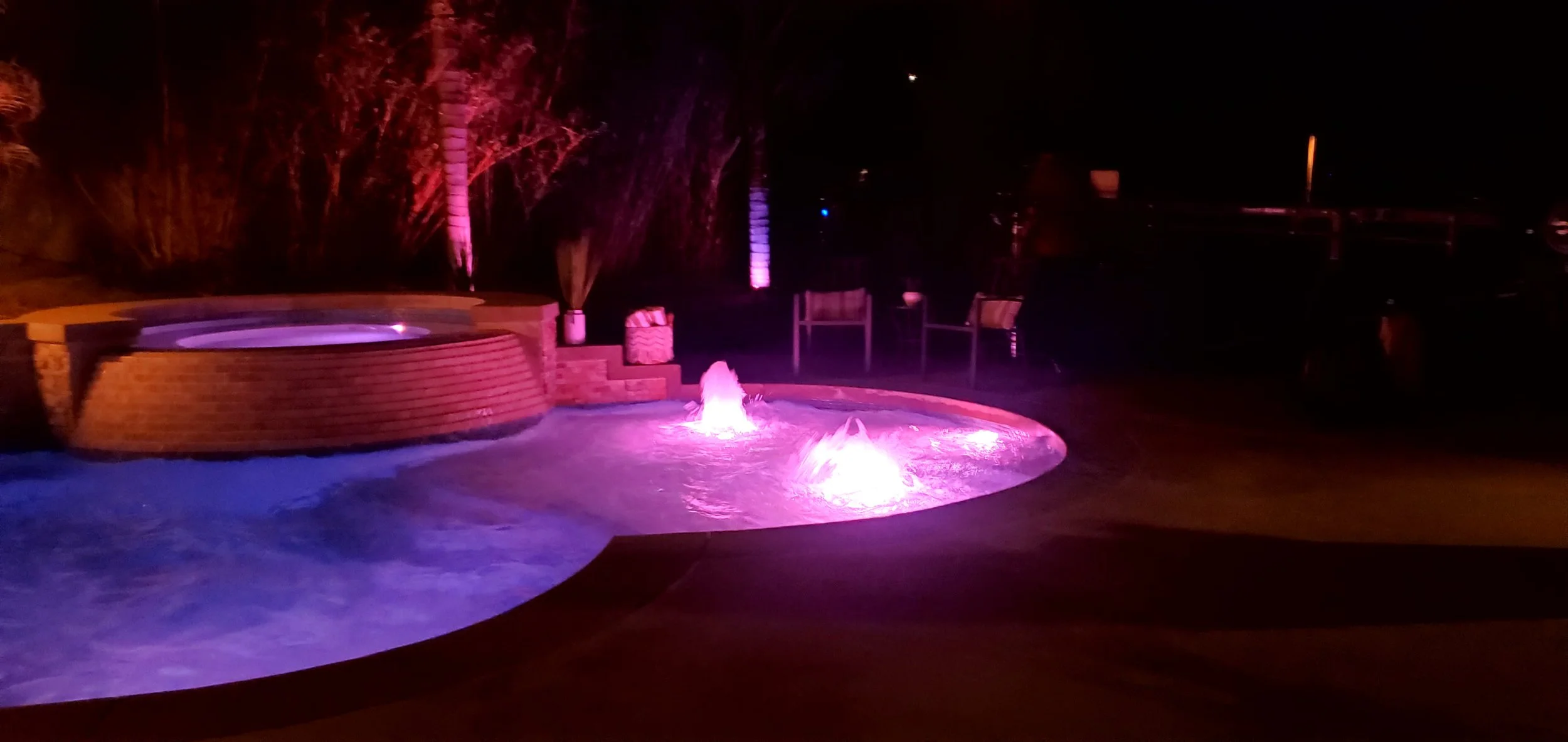 "Luxury pool with Jandy Infinite WaterColors LED lighting and automated water jets, installed by Casabona’s Renovation in Miami."