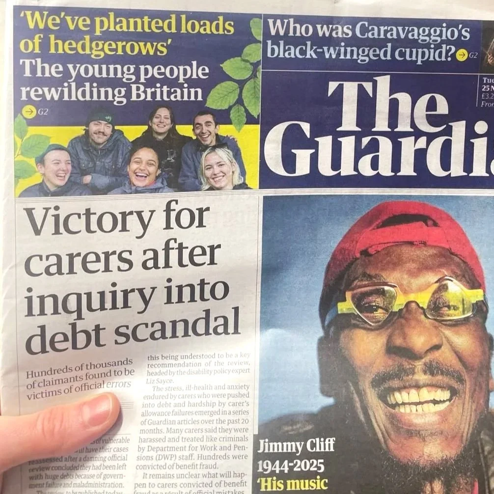 Front page of The Guardian newspaper featuring a headline about a debt scandal inquiry and a photograph of a man named Jimmy Cliff with a red cap, glasses, and a broad smile.