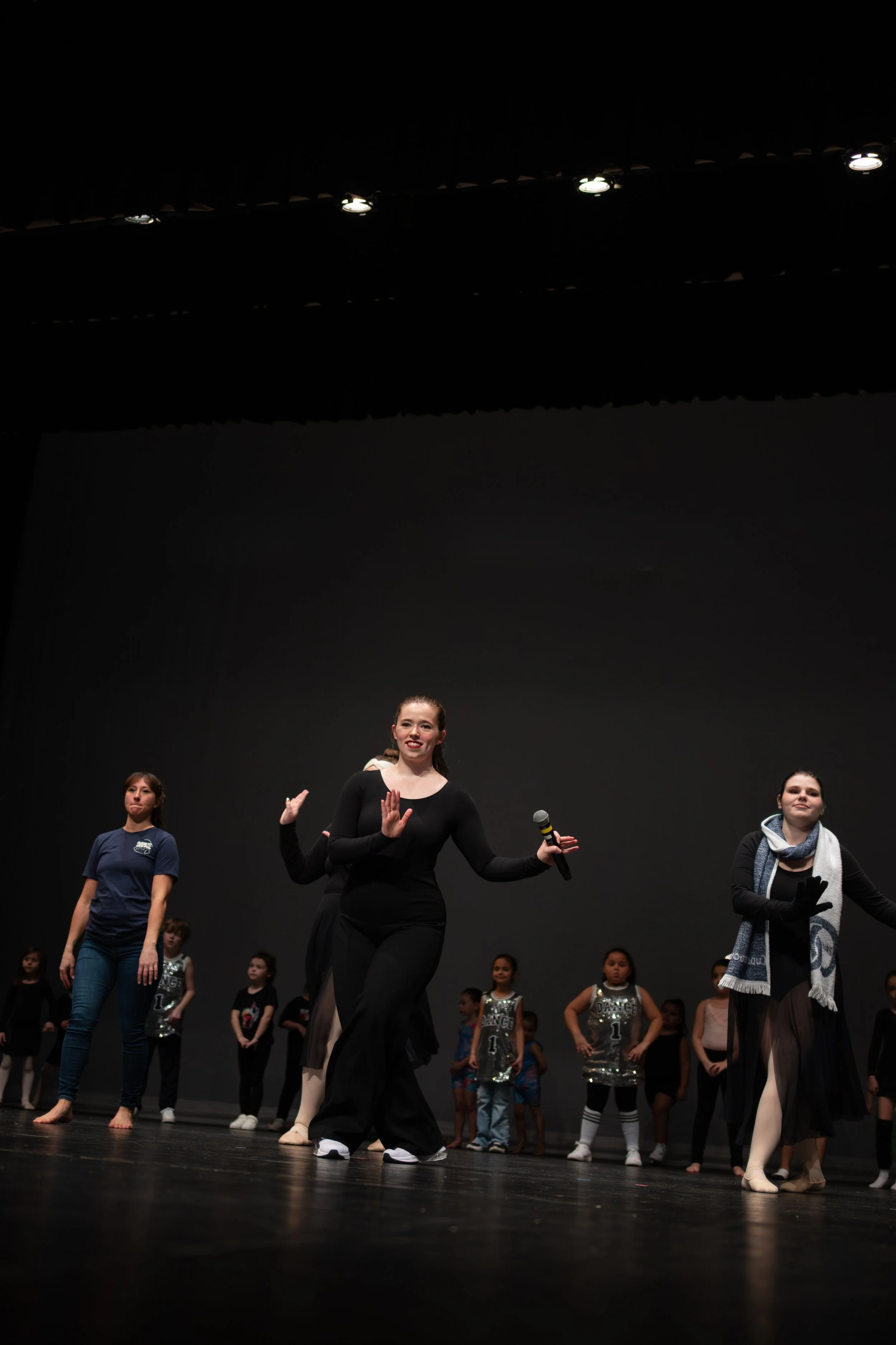 People performing on stage during a dance or theater rehearsal or performance.