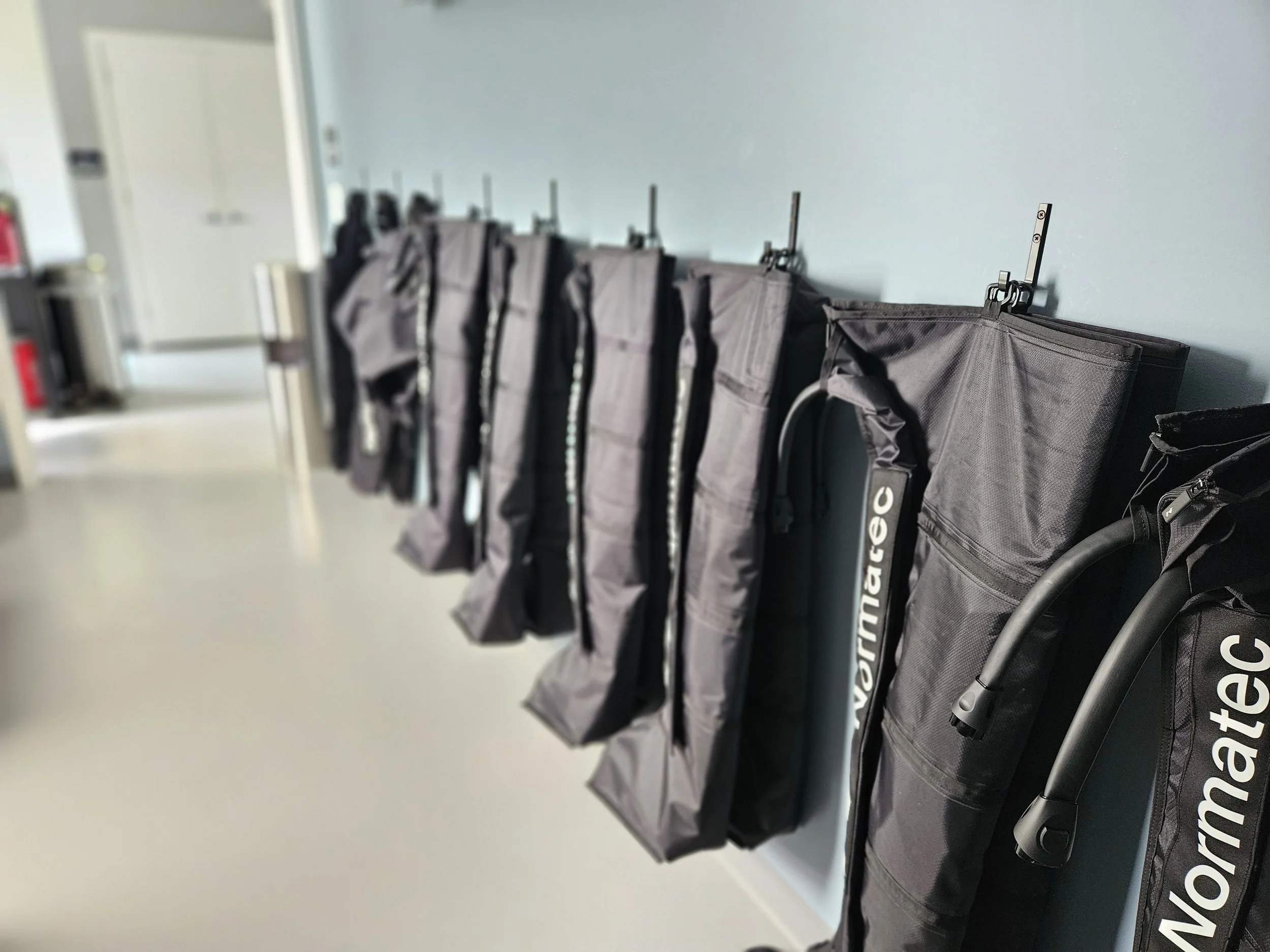 A photo of a room with compression boots hanging on a blue wall located near Paoli, PA.