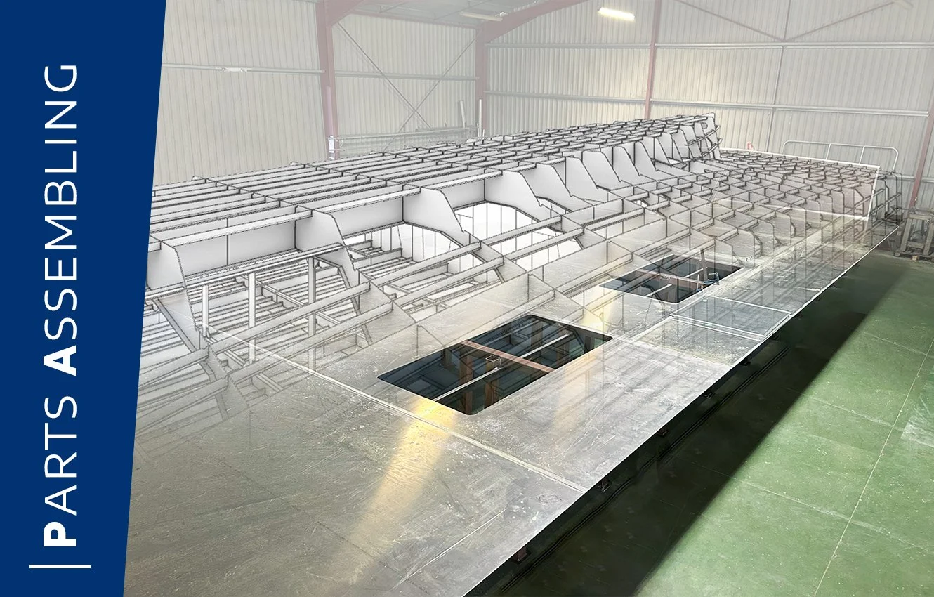 View of a 3D model and a photo of an aluminum structure under construction at a shipyard, used for assembly or construction.