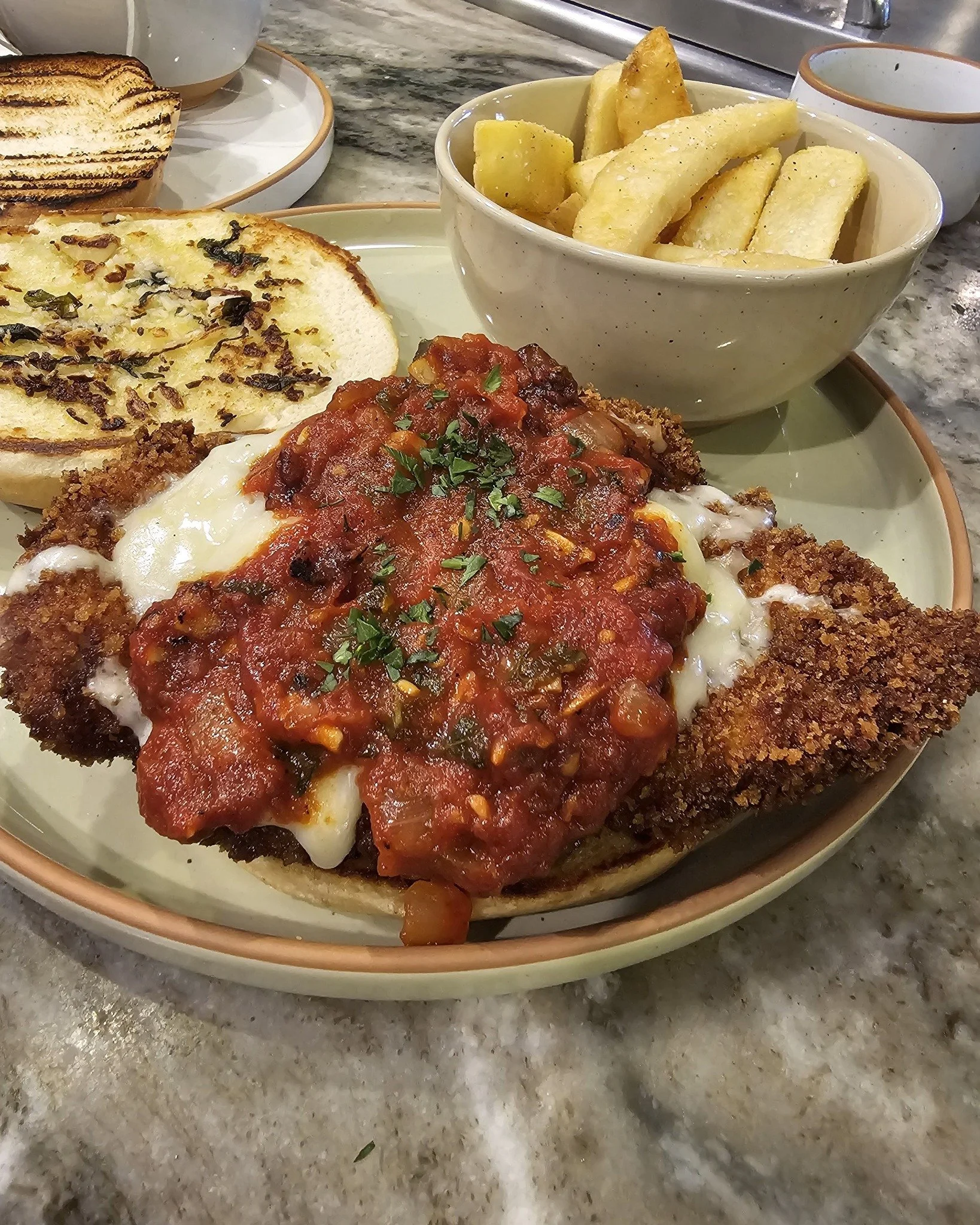 Stop by for our version of the chicken parm for lunch today! Our buttermilk-marinated chicken breast is lightly coated in seasoned breadcrumbs, fried until golden brown, and topped with melted mozzarella and provolone. Blended San Marzano tomato sauc