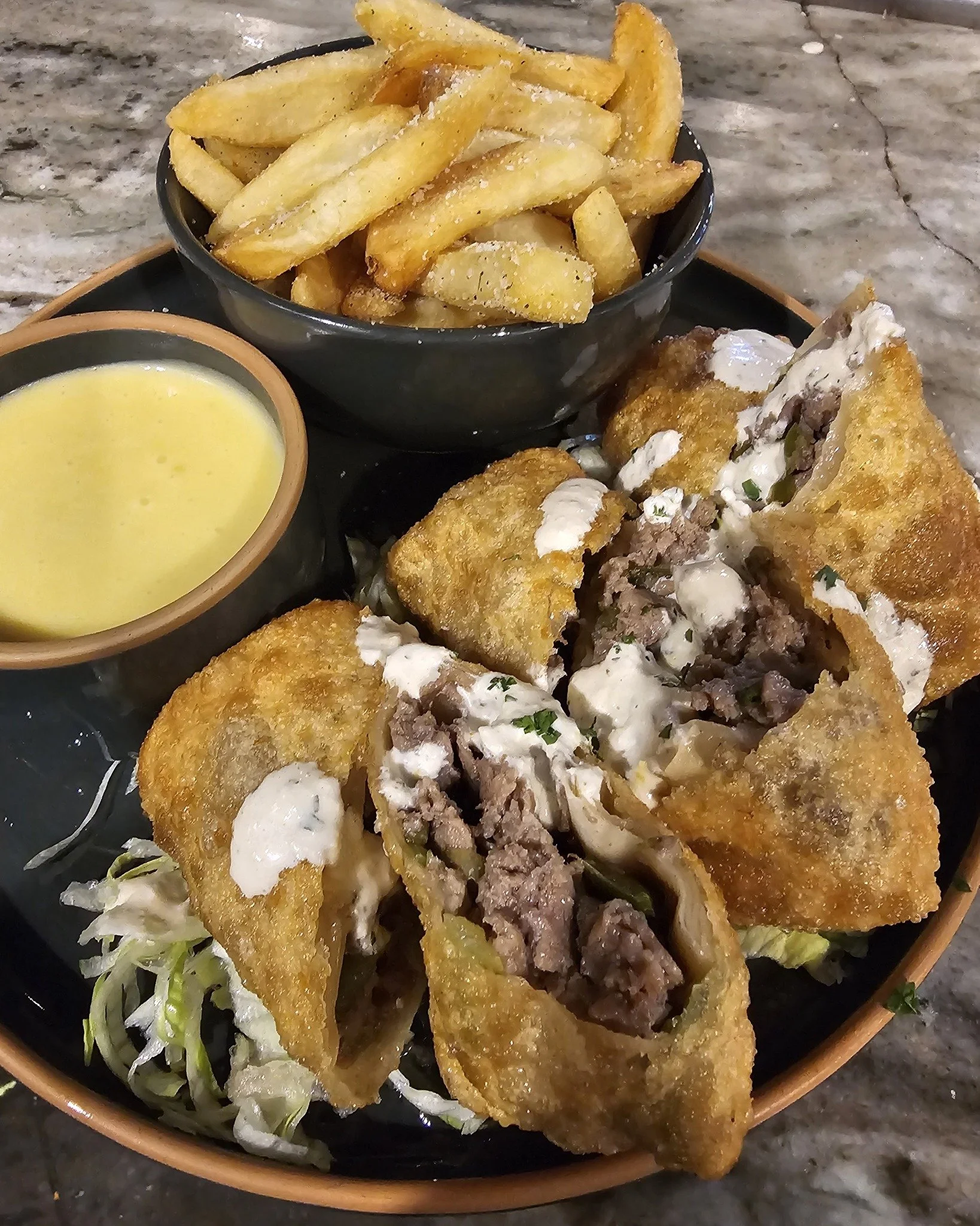 Hi, when you get hungry for lunch today, keep the Fresh Prince in mind! Call ahead for pickup. Thinly sliced, pan-seared ribeye with onions and peppers wrapped in a golden-brown egg roll, topped with a spicy horseradish sauce. Served with a side of h
