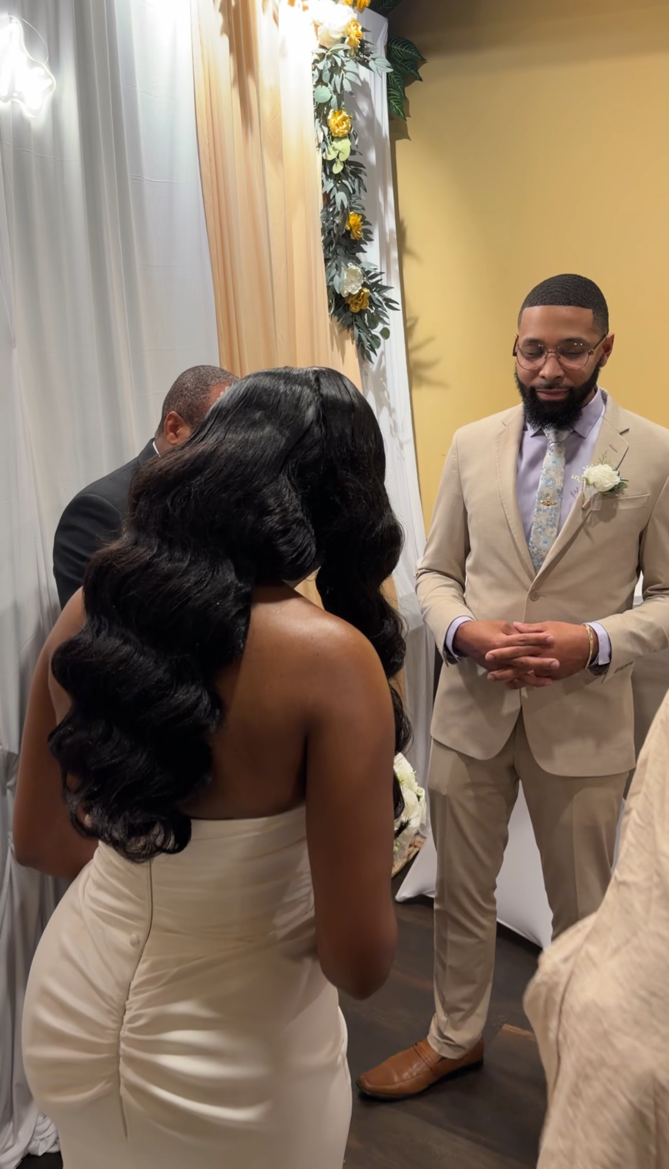 Bride and groom praying during their wedding ceremony.