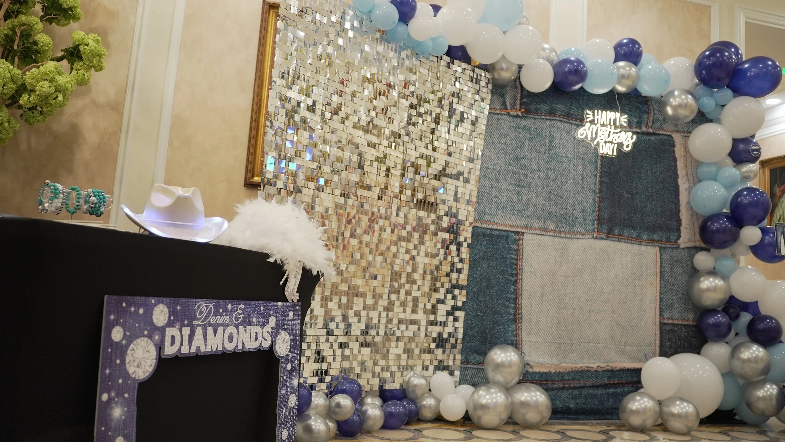 Mother's Day photo-op featuring a denim backdrop and balloon display.