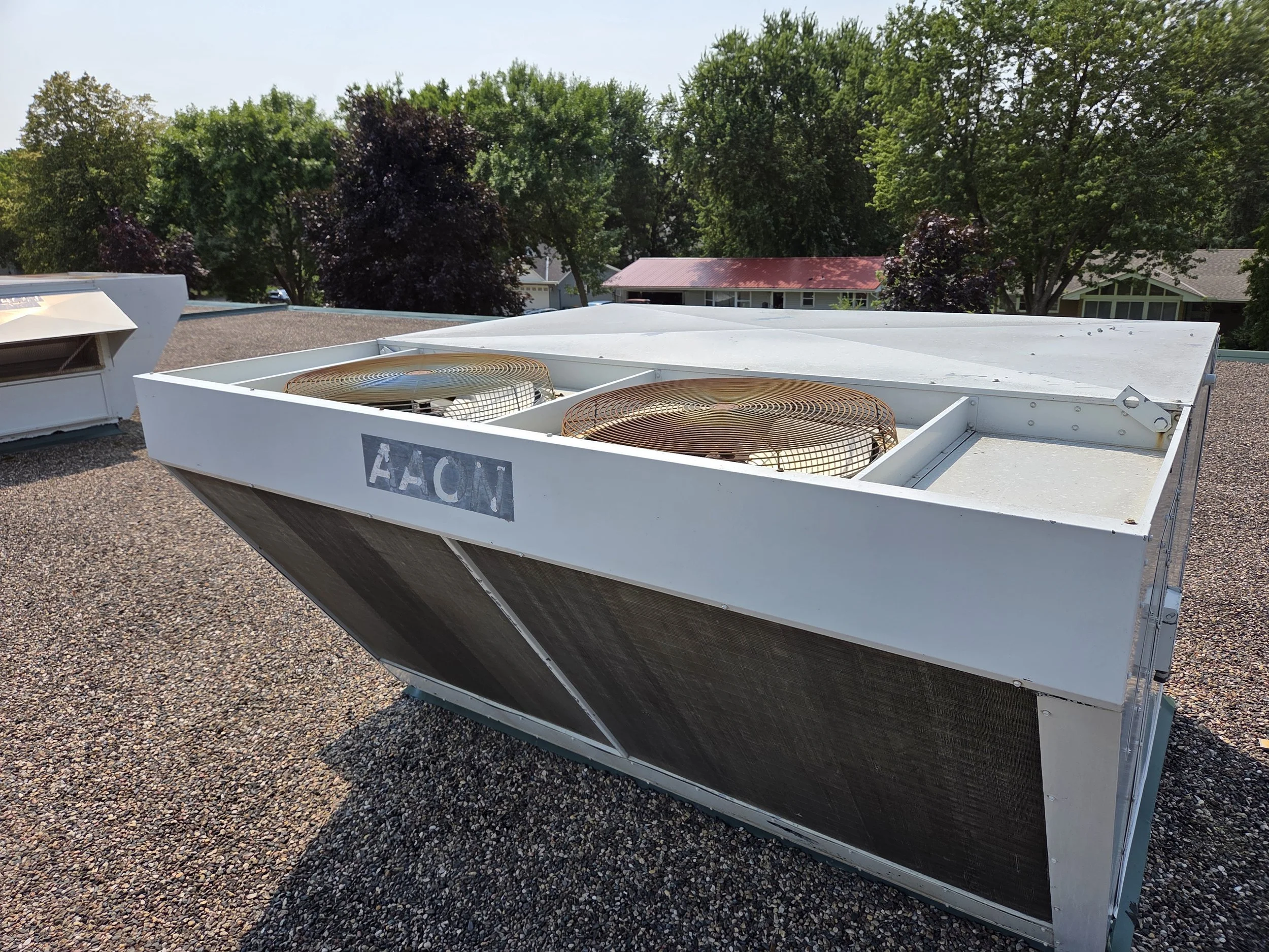 A view of a rooftop with two large HVAC units at Wagner Education Building.