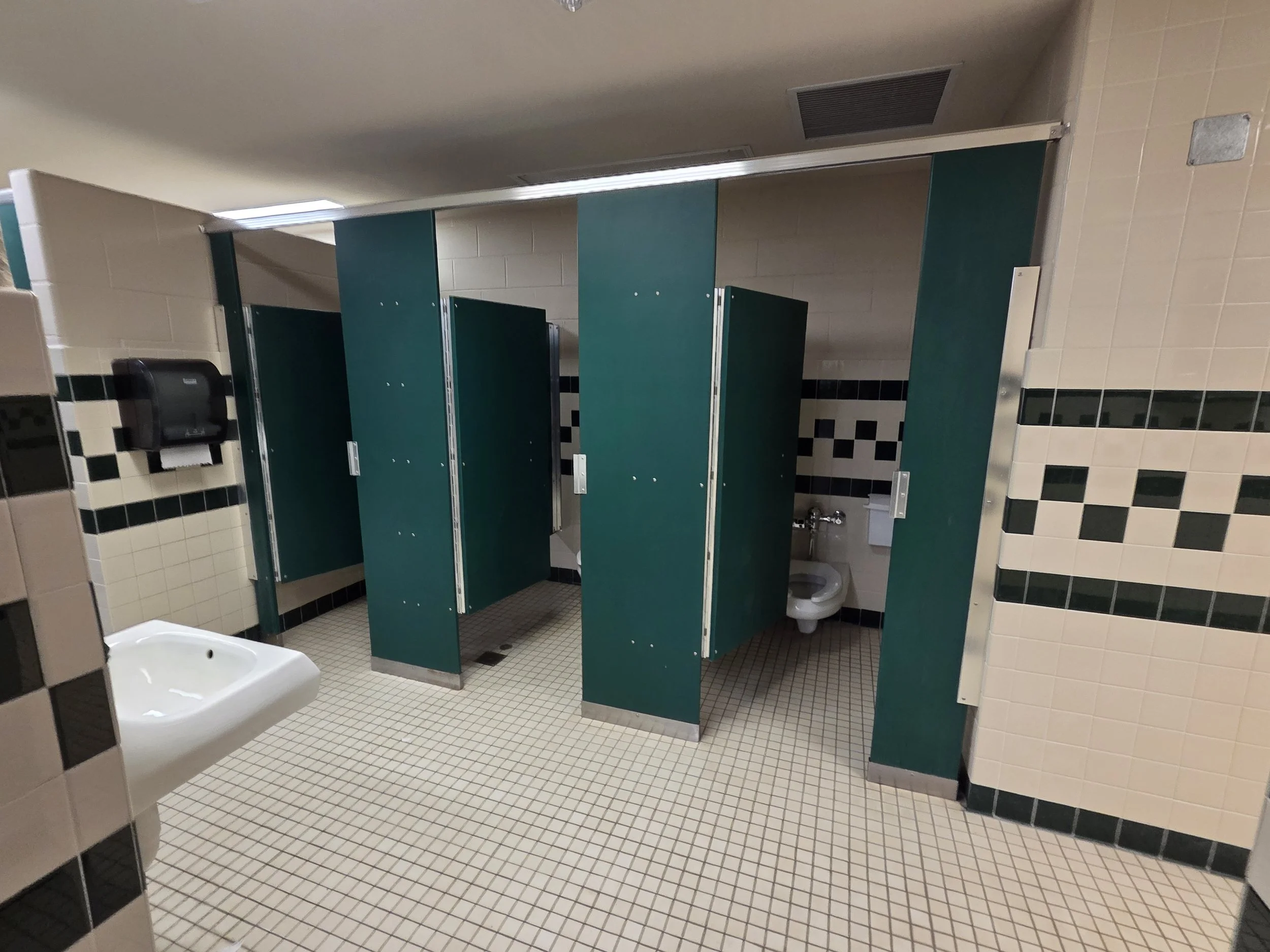 A photo showing the outdated restrooms in the locker rooms of the Litchfield Middle/High School.
