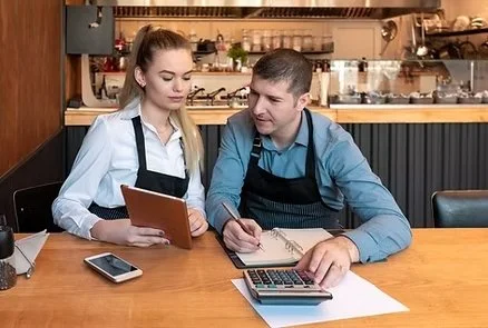 Small business owners and employees handling their bookkeeping.