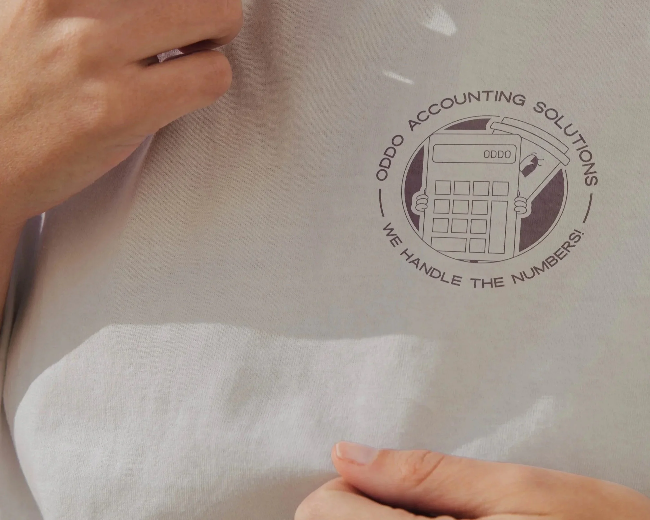 Branded Oddo Accounting Solutions illustration displayed on a shirt.