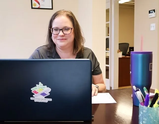 Oddo Accounting Solutions owner Kate Oddo working in front of a laptop.