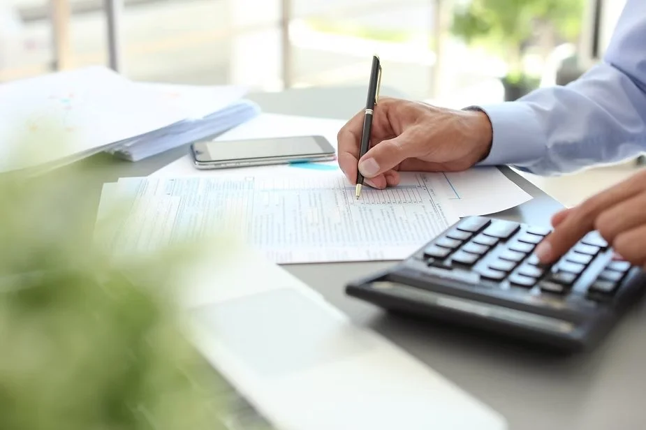 Small business owner working on financial forms.