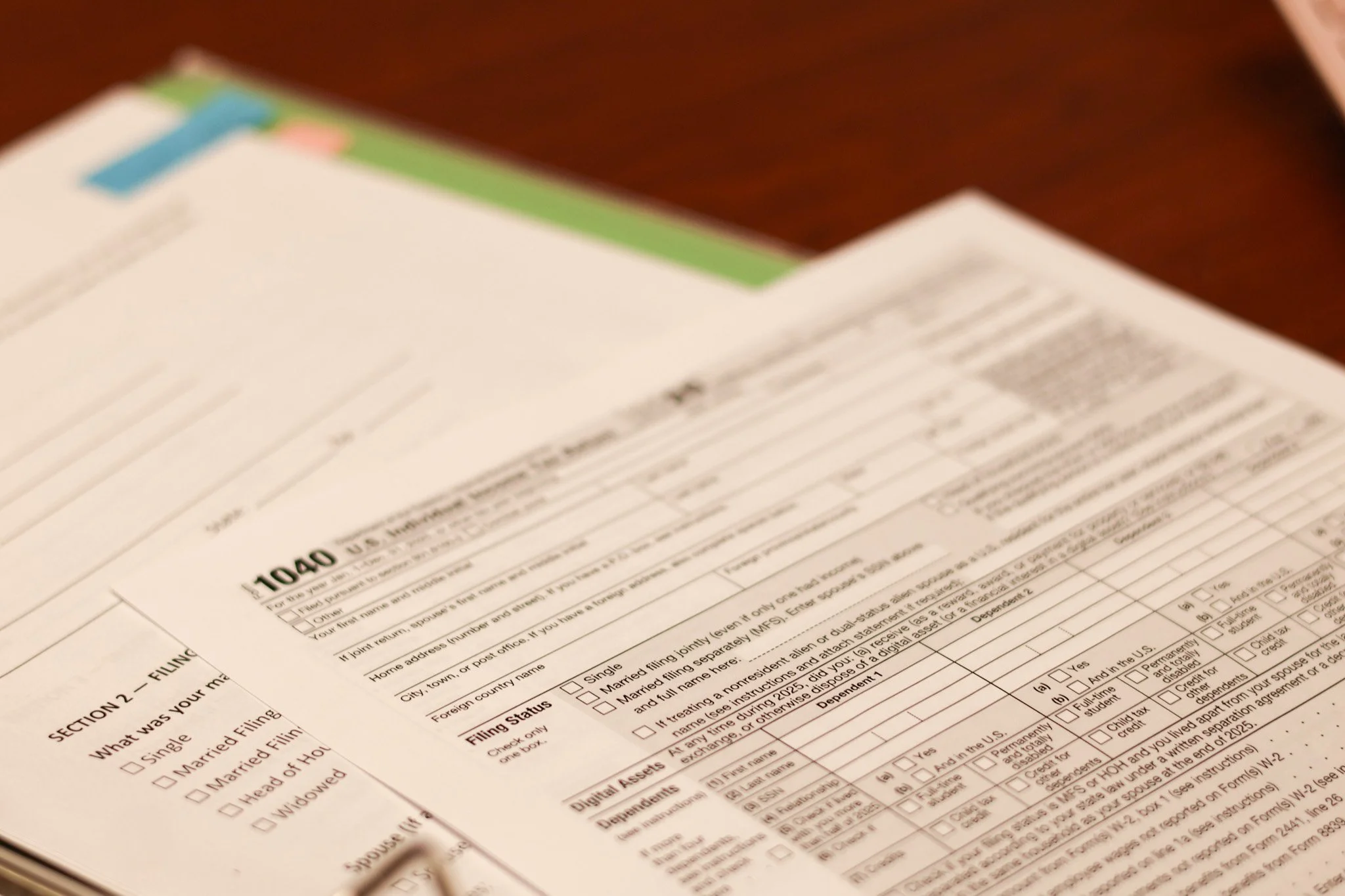 Close-up of a filled-out tax form on a wooden desk.