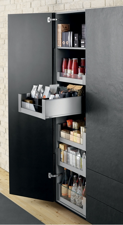 Open black pantry door revealing shelves filled with food, jars, and storage containers.
