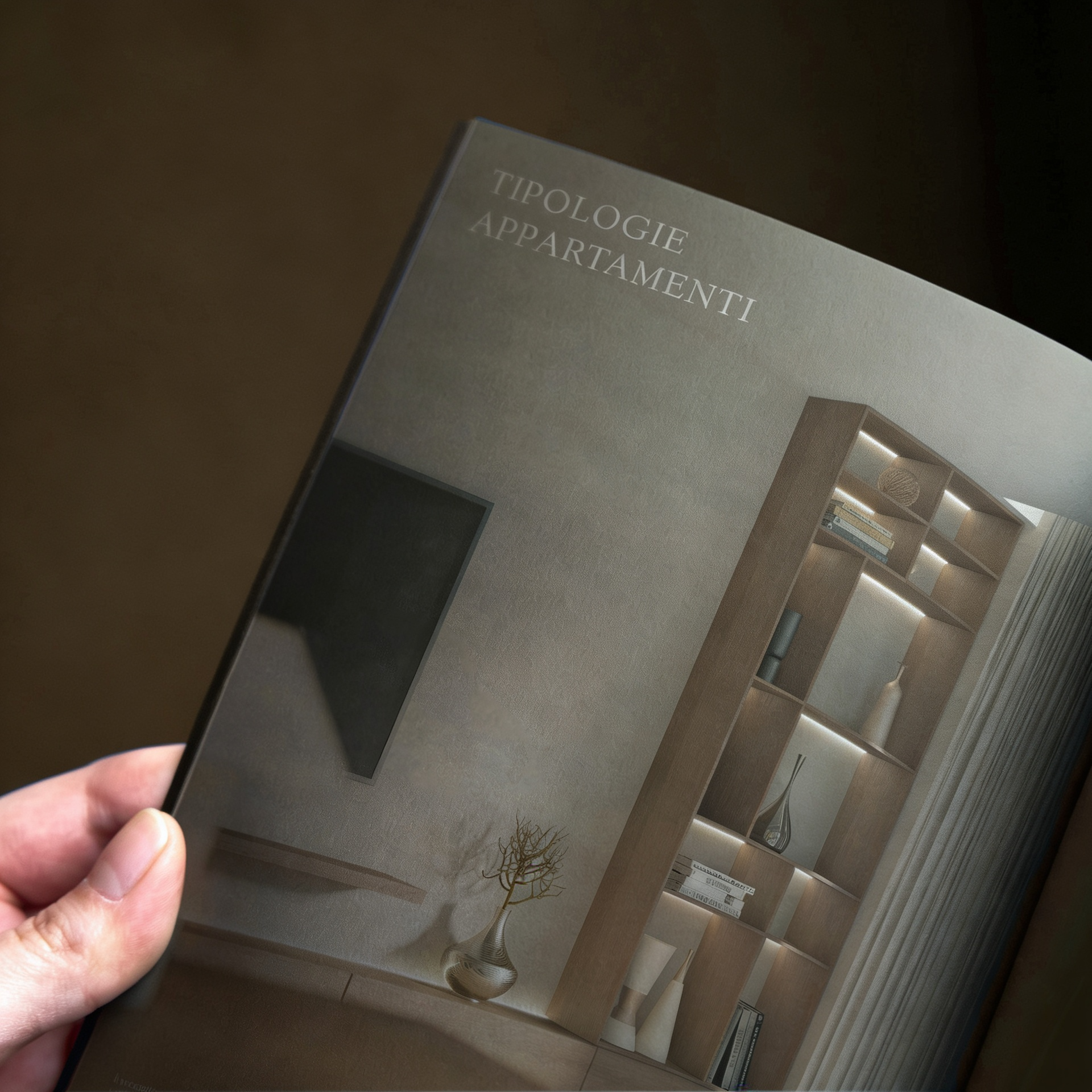 Libro intitolato 'Tipologie Appartamenti' con immagine di un appartamento moderno e una grande pianta