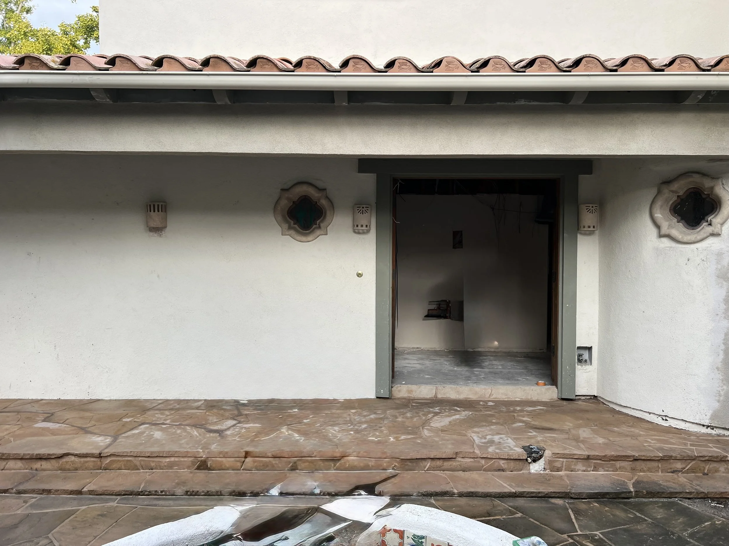 'This Picture shows the exterior of the house, where a metal beam was installed, covered, and finished with stucco, enhancing the structural support and exterior appearance.”