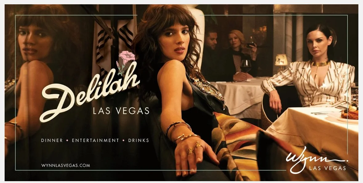 Promotional image for Delilah in Las Vegas showing women dining at a fancy restaurant with the text 'Delilah Las Vegas' and details about dinner, entertainment, and drinks.