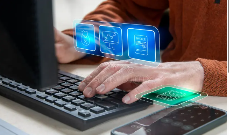 Person using a laptop with floating digital icons for tax, charts, invoice, and calculator, alongside a smartphone on a table.
