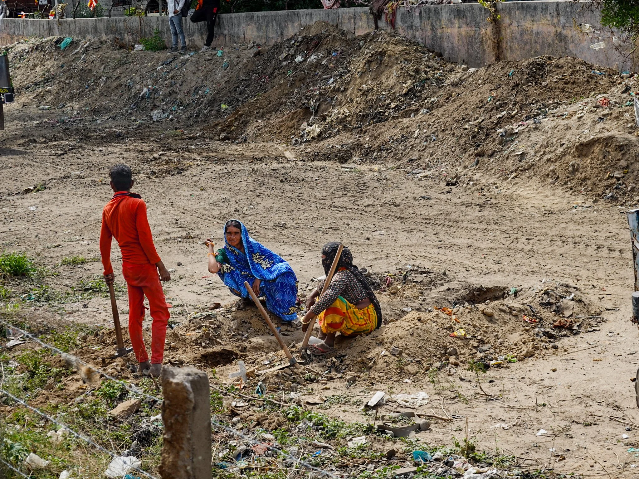 locals sitting along the train tracks in the Indian countryside between Jaipur & Agra