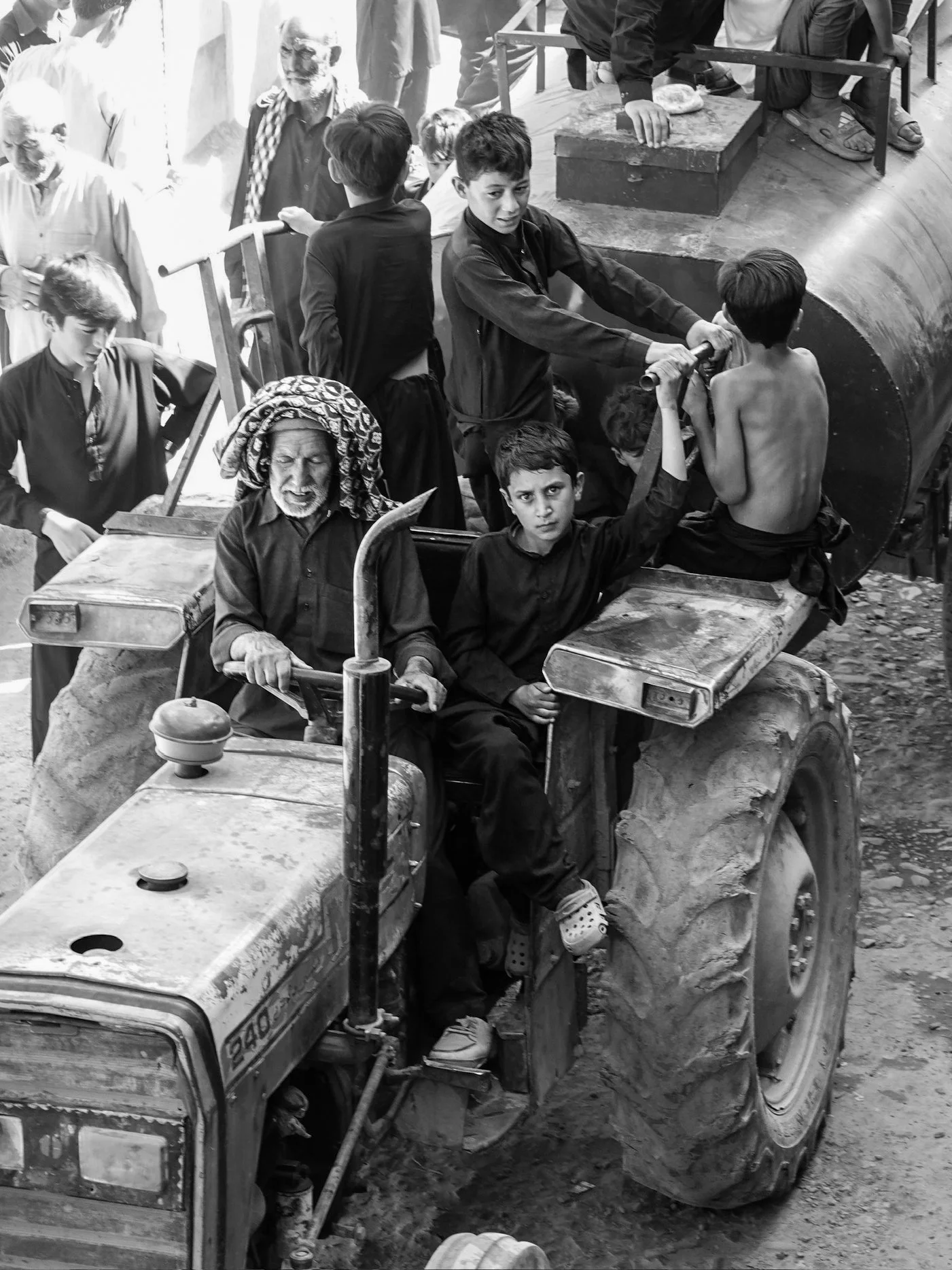 local boys passing out water from a tractor during the Muharram Procession in Pakistan