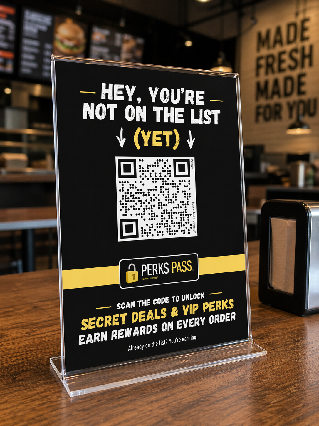 Sign in a restaurant promoting a QR code for secret deals and VIP perks, with text indicating the customer is not on the list yet.