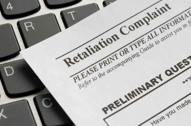 Retaliation document resting on a laptop keyboard
