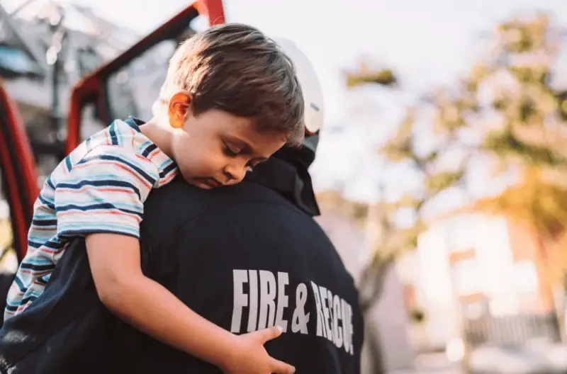 Firefighter saving a child during an emergency rescue