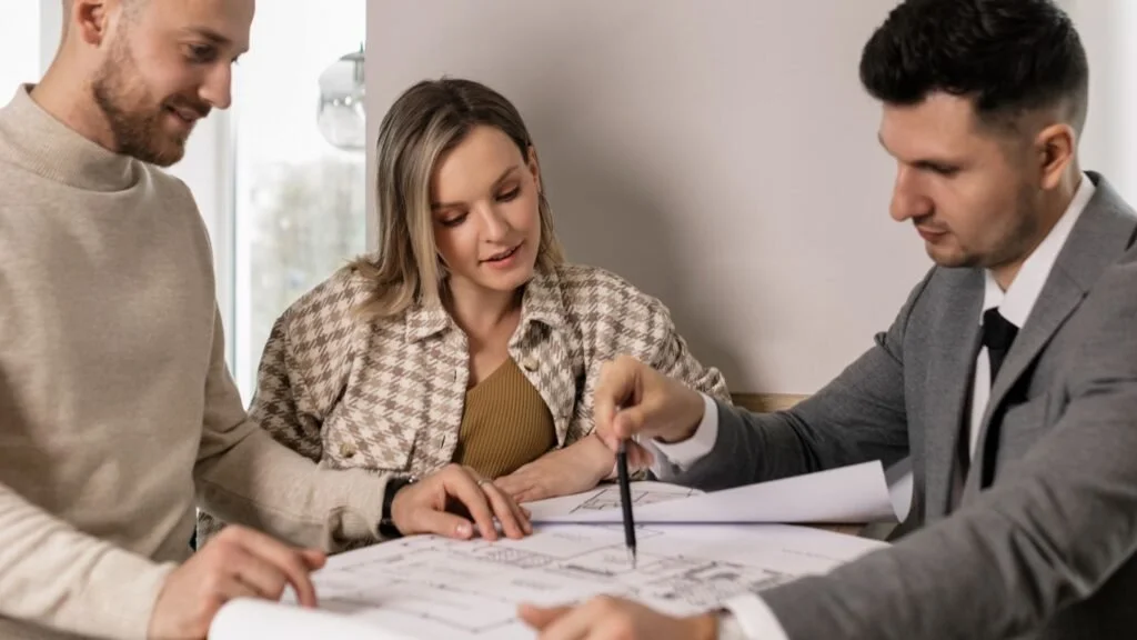 Professionals working together over a blueprint plan