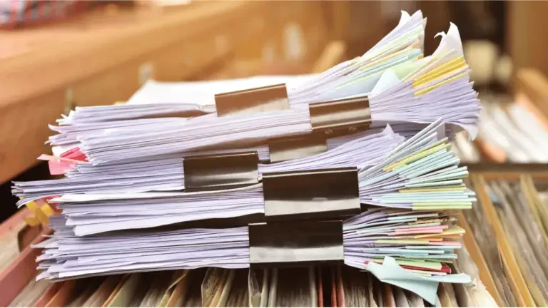 Office paperwork stacked on a desk