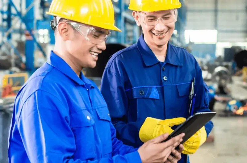 Two workers looking at a tablet together
