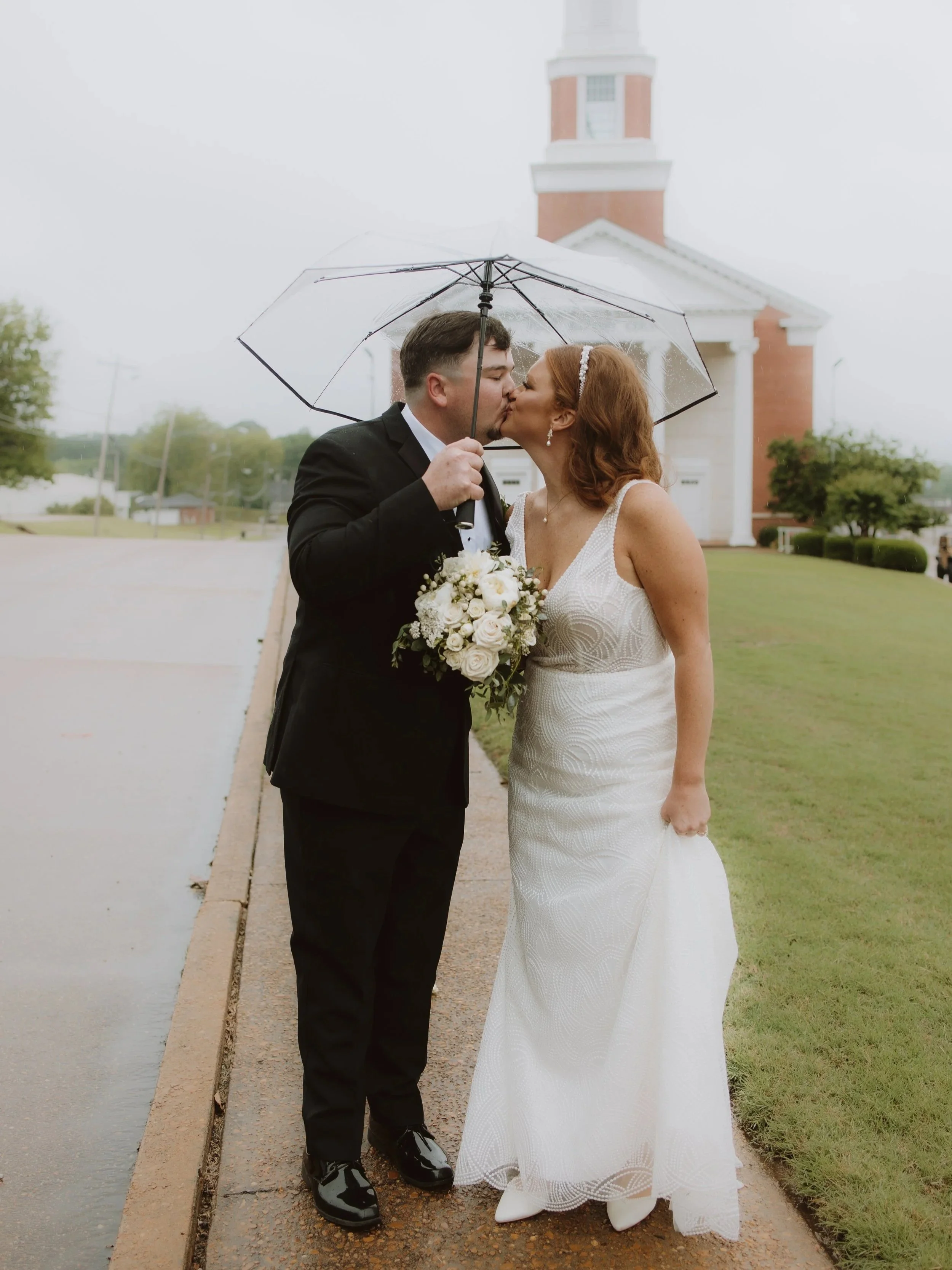 Mississippi bride and groom kissing in front of a church.
