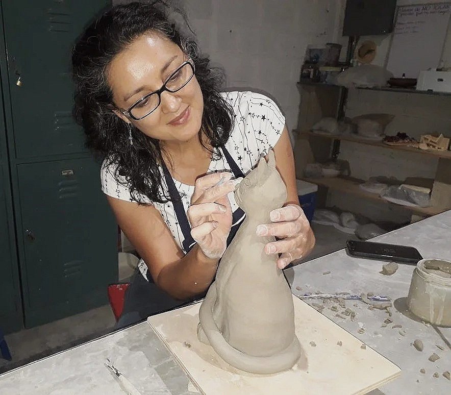 Fatimah Araneta hand-shaping a ceramic sculpture in the Gaspart Studio ceramics workshop, demonstrating the techniques students learn through hands-on instruction.
