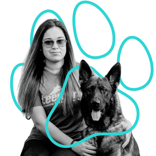 Alex Soliz, canine relationship coach at Wholistic Canine, sitting with a German Shepherd inside a teal paw print outline