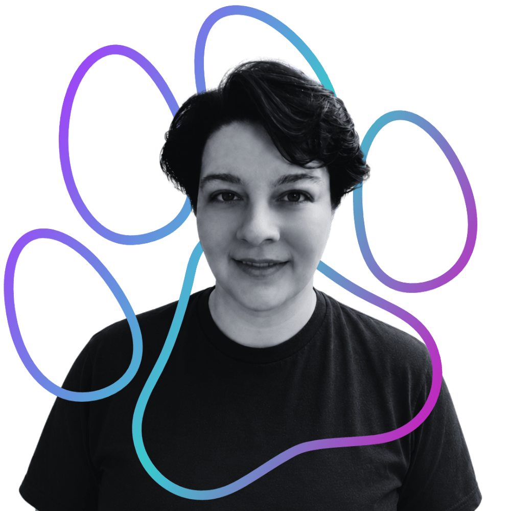 Black and white portrait of a person (Mitch, 
Foundations & Socialization Specialist for Wholistic Canine) with short hair, wearing a black shirt, with a colorful gradient paw print around them.